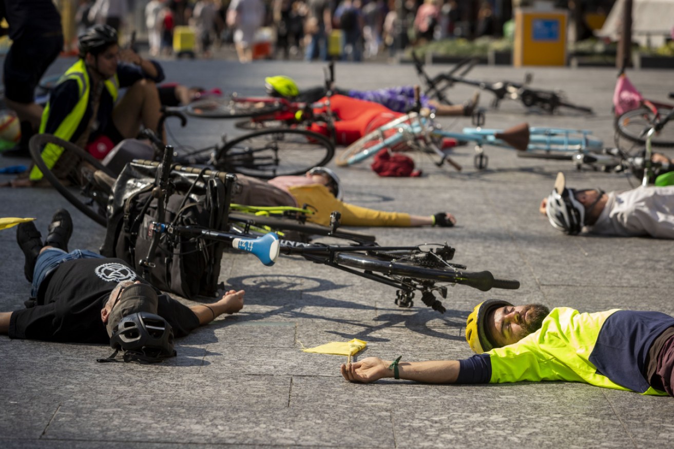 Protesters laying down on a busy Melbourne bridge during a recent rally.