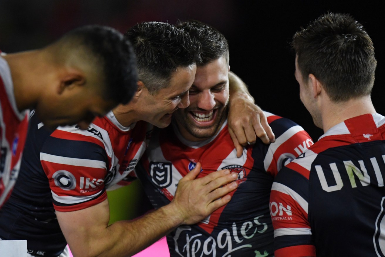 An elated Cooper Cronk talks with winning-try scorer James Tedesco after the grand final win. 