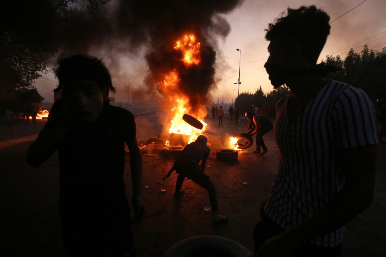 Iraqi protesters burn tyres during a demonstration against state corruption, failing public services, and unemployment, in the Iraqi capital.