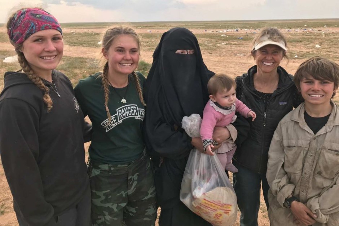 Australian woman Zehra Duman (centre) with aid workers in Syria late in 2019.