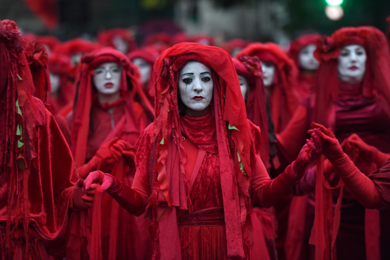 Extinction Rebellion protests, such as the Red Brigade of The Invisible Circus in London, are causing chaos are around the world.