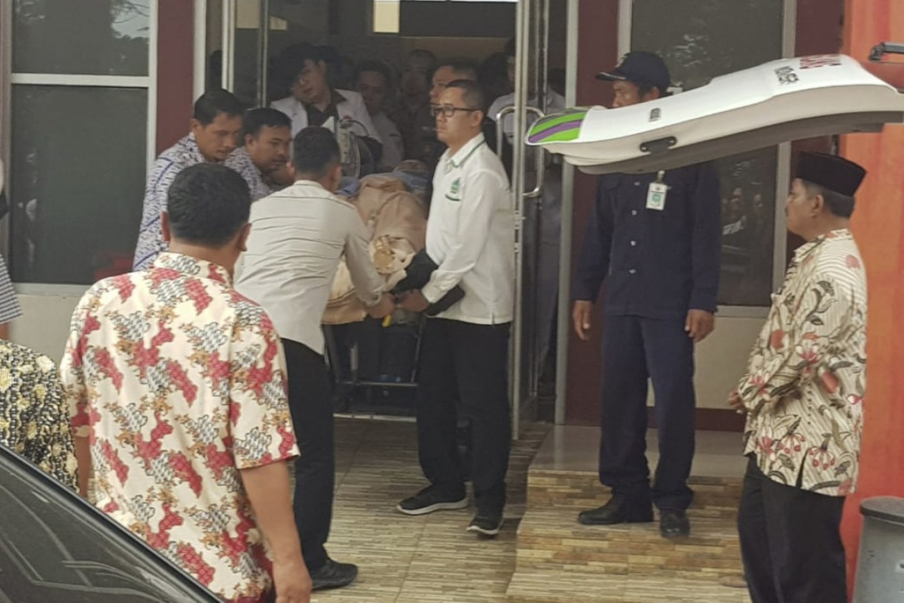 Medics wheel Indonesian security minister Wiranto on a stretcher to be evacuated to Jakarta on Thursday. 