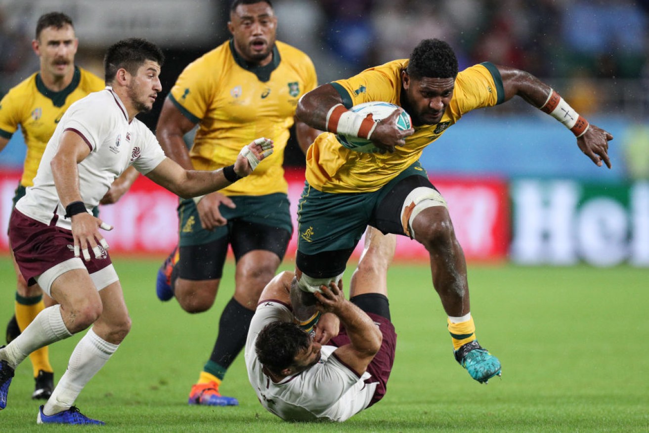 Isi Naisarani tries to escape the tackle of Georgia's Davit Kacharava in the Rugby World Cup 2019 Group D game in Japan.