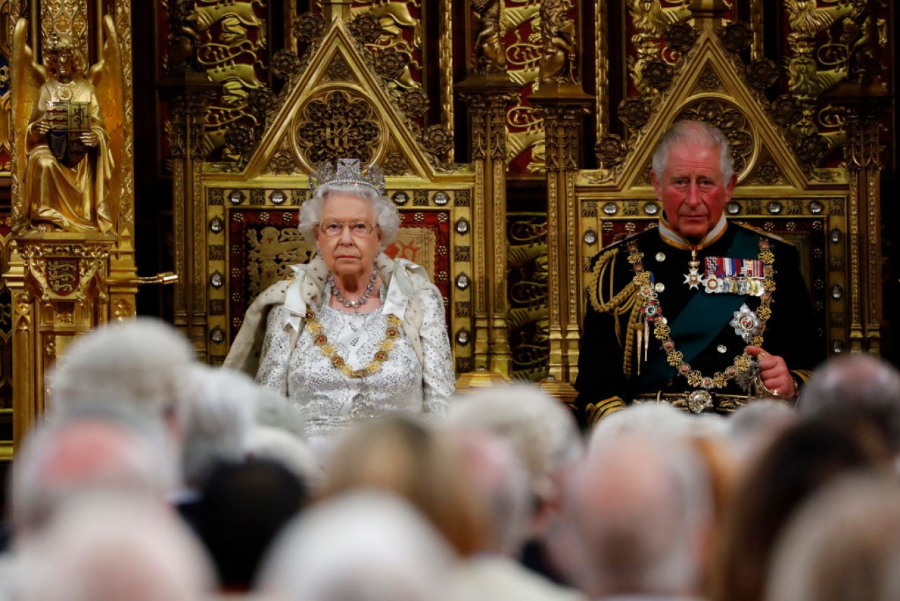 Britain's Queen Elizabeth II takes her seat on The Sovereign's Throne in the House of Lords next to Prince Charles, Prince of Wales.