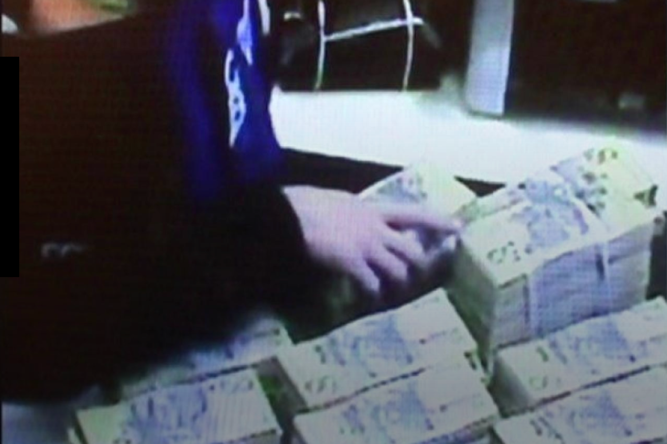 CCTV shows high rollers handing over cash.