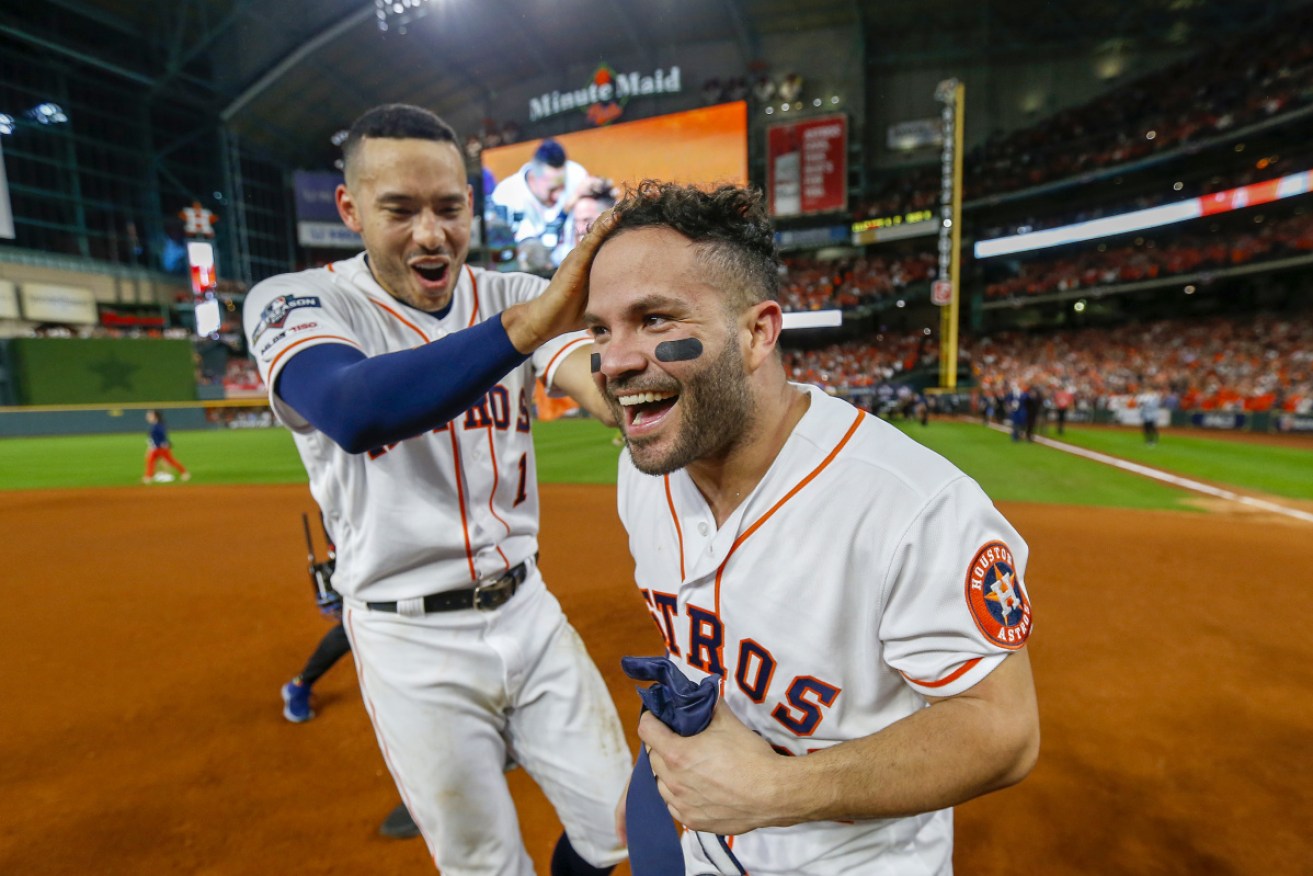 World Series bound: Jose Altuve of the Houston Astros is congratulated by his teammate Carlos Correa.