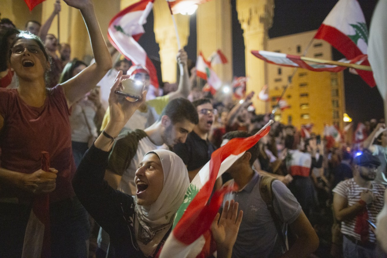 Protesters gather and dance during an anti-government demonstration in central Beirut.