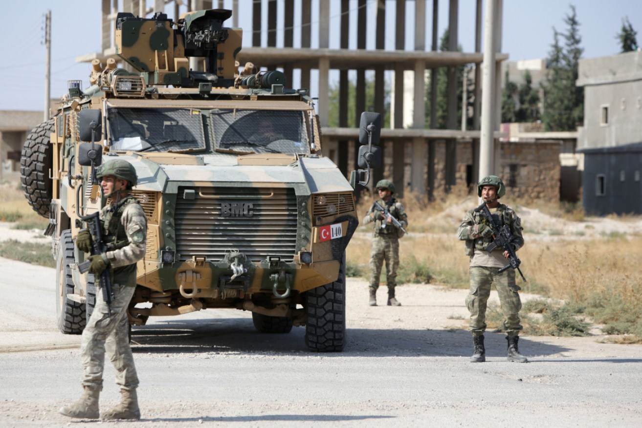 Turkish soldiers patrol the northern Syrian Kurdish town of Tal Abyad.