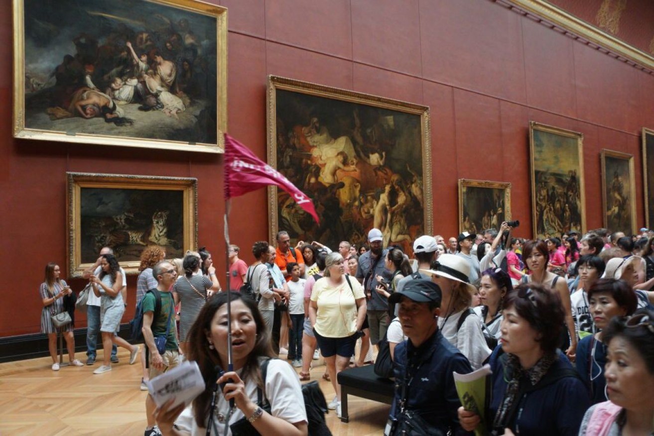 Chinese tourists among the crowds at the Louvre in Paris.