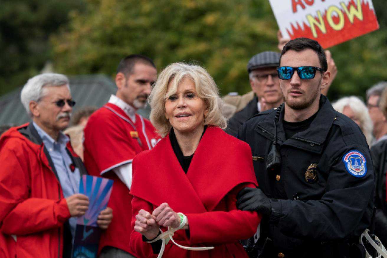 Jane Fonda shouts her thanks to BAFTA as she is led away from the climate protest.