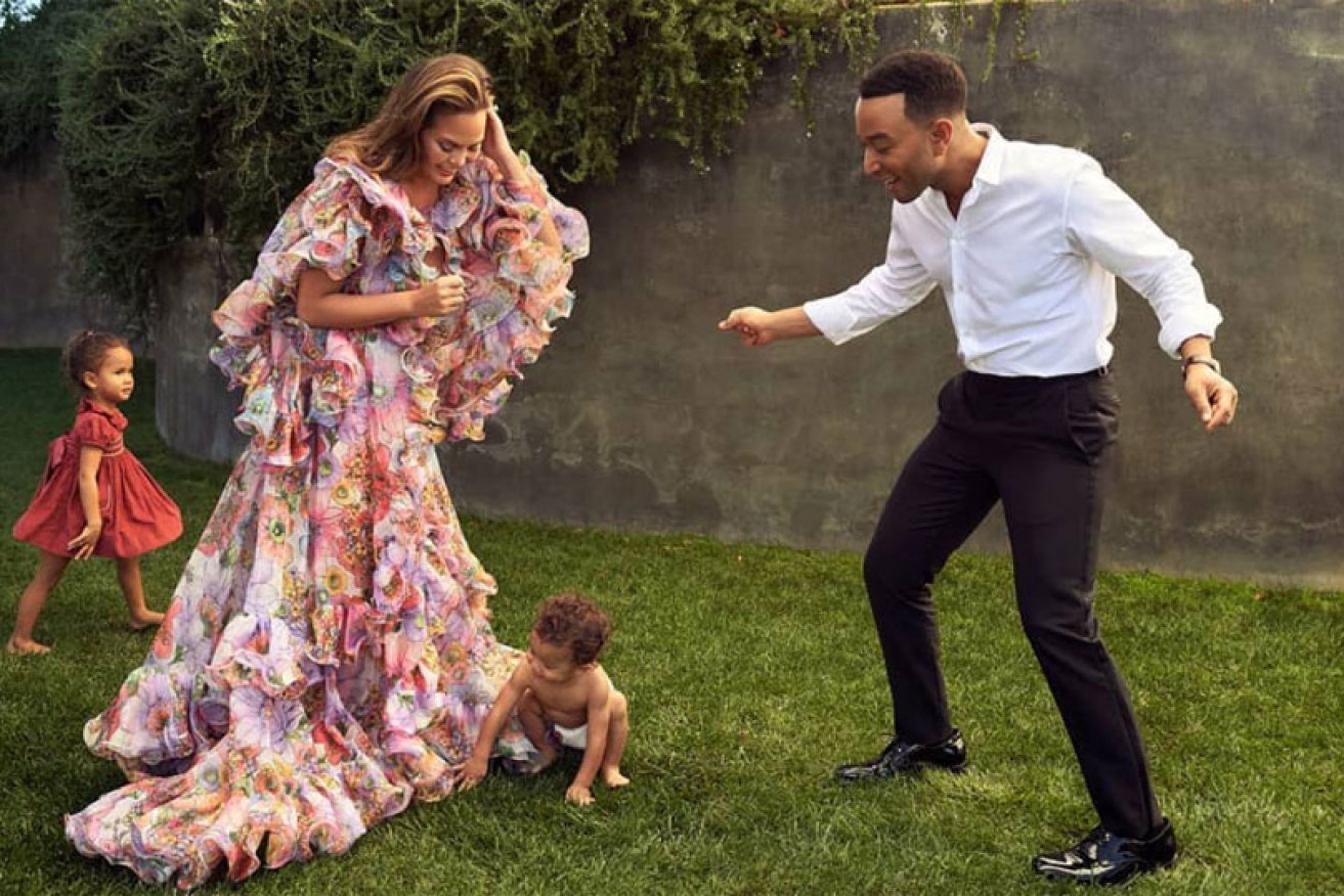 John Legend and Chrissy Teigen with kids Luna and Miles "singing Christmas songs in October" in <i>Vanity Fair.</i>