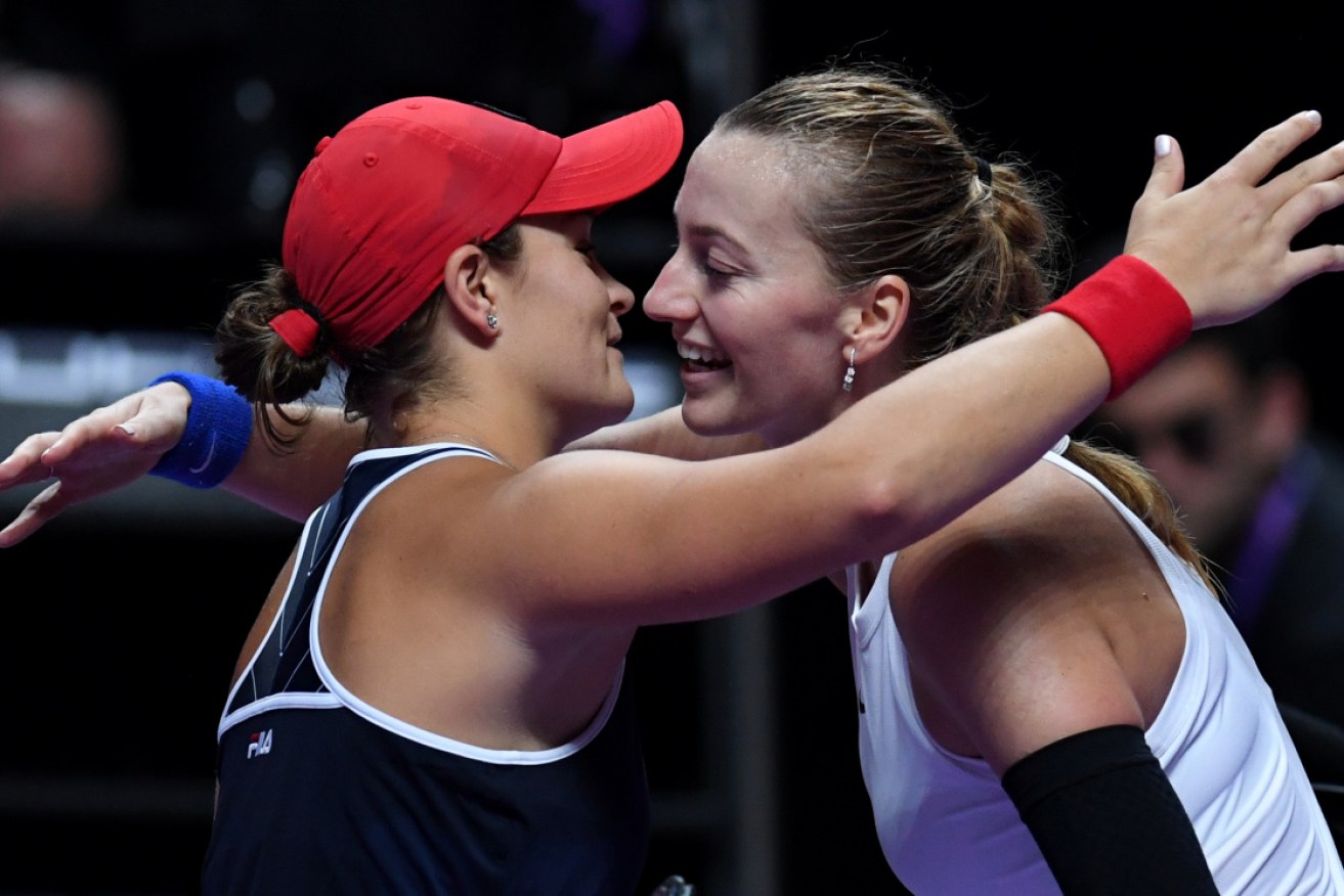 Ashleigh Barty and Petra Kvitova hug after their match at the WTA Finals in Shenzhen.