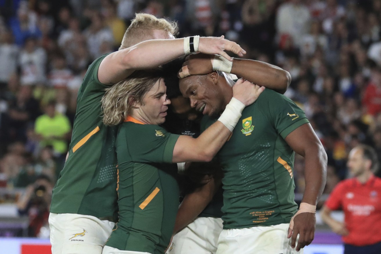 South Africa's Makazole Mapimpi is mobbed after scoring his game-breaking try.  