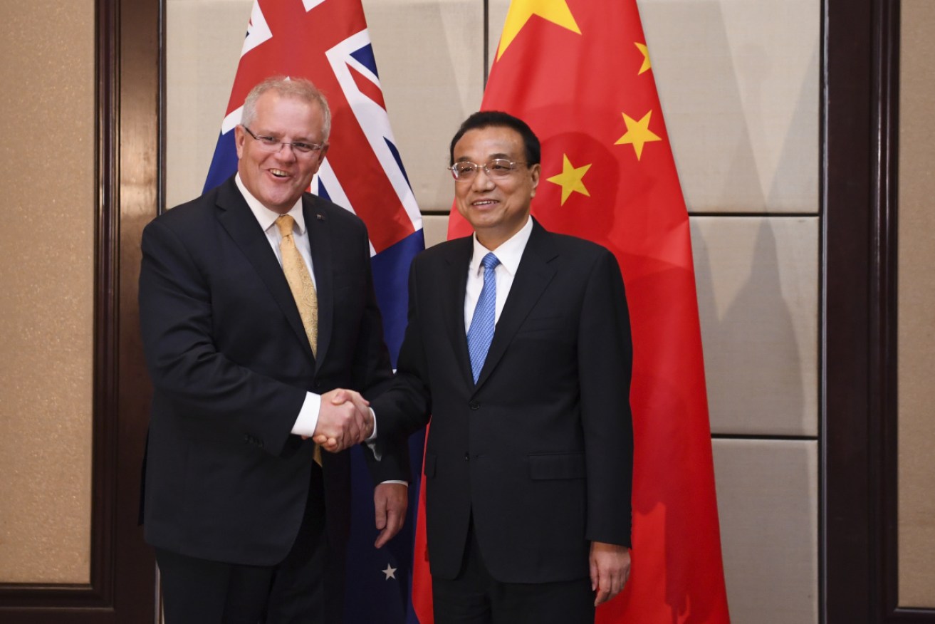 Prime Minister Scott Morrison chats to China Premier Li Keqiang before the East Asia Summit in Bangkok on Sunday.