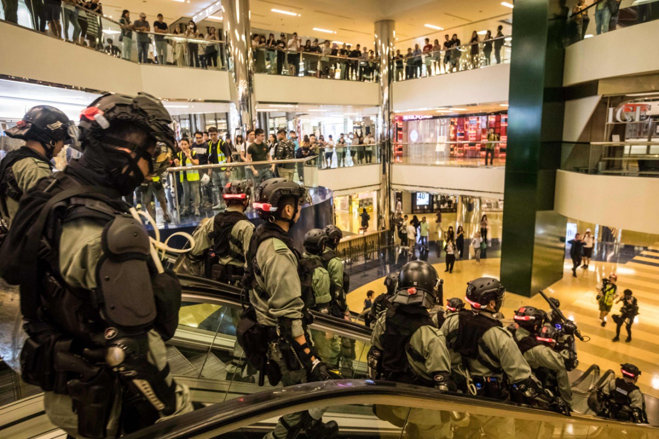 Riot police inside the City Plaza mall, the scene of a bloody knife fight that wounded six people.