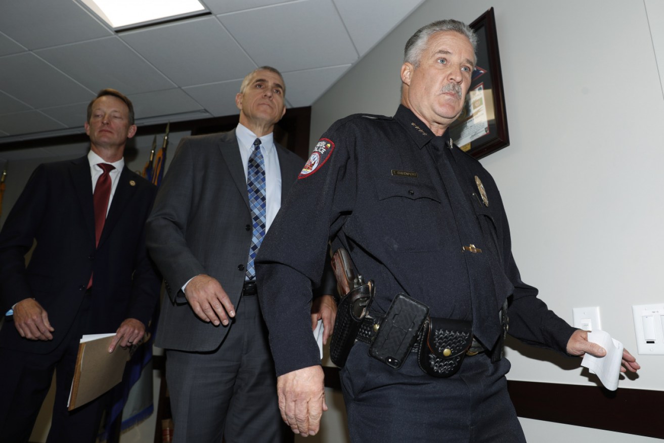 Law enforcement officials leave a press conference after announcing the arrest of Richard Holzer.