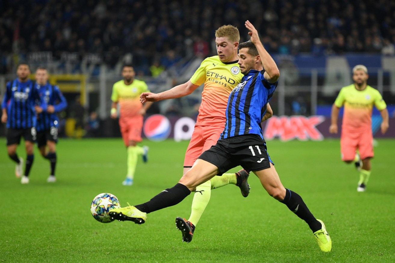 Kevin De Bruyne of Manchester City battles for possession with Atalanta's Remo Freuler.