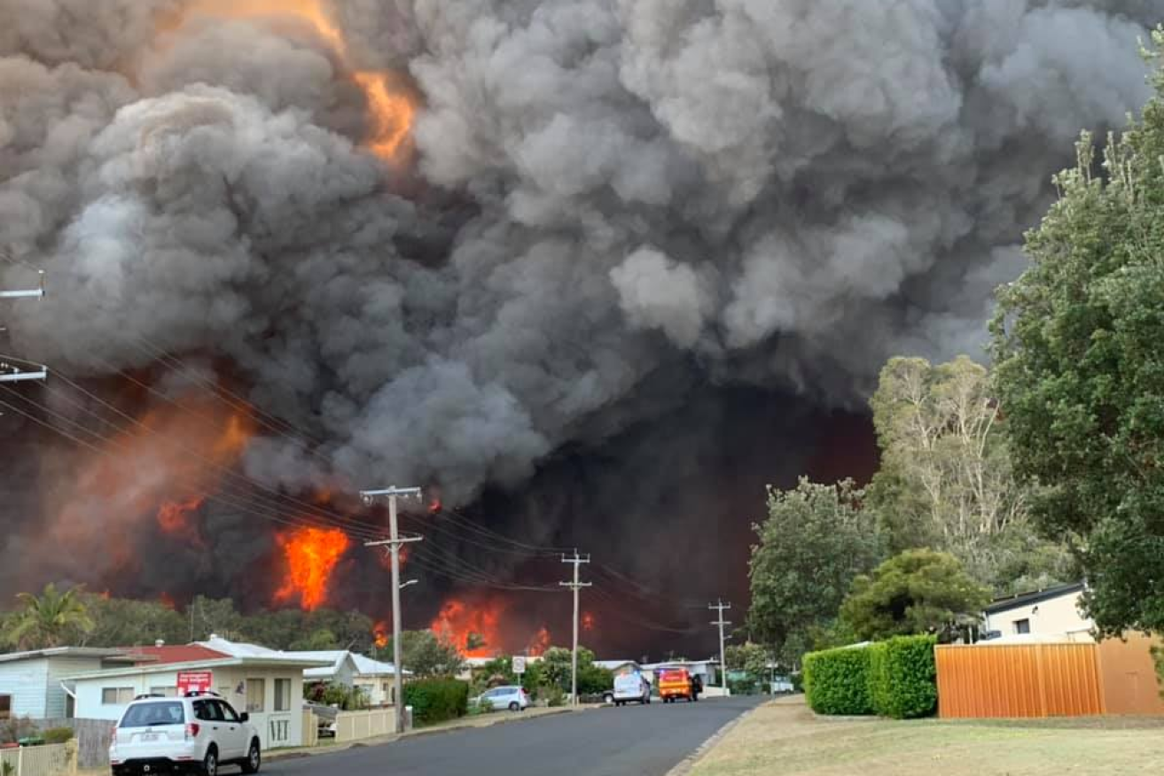 A bushfire and fearsome cloud loom over Harrington, a village on the mid north coast of NSW. 