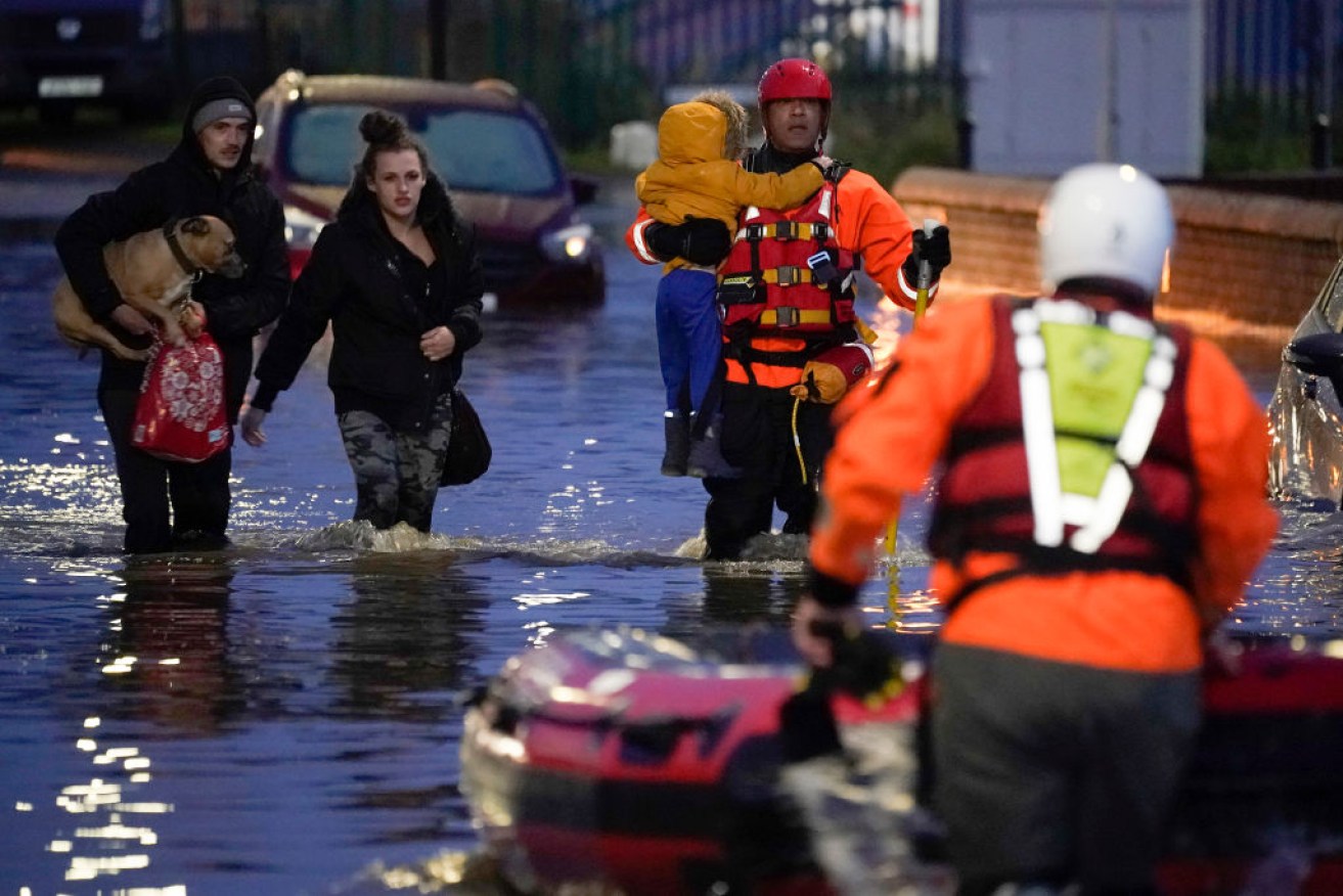 A young child is rescued by a crew from South Yorkshire Fire and Rescue Service after severe flooding in Doncaster.