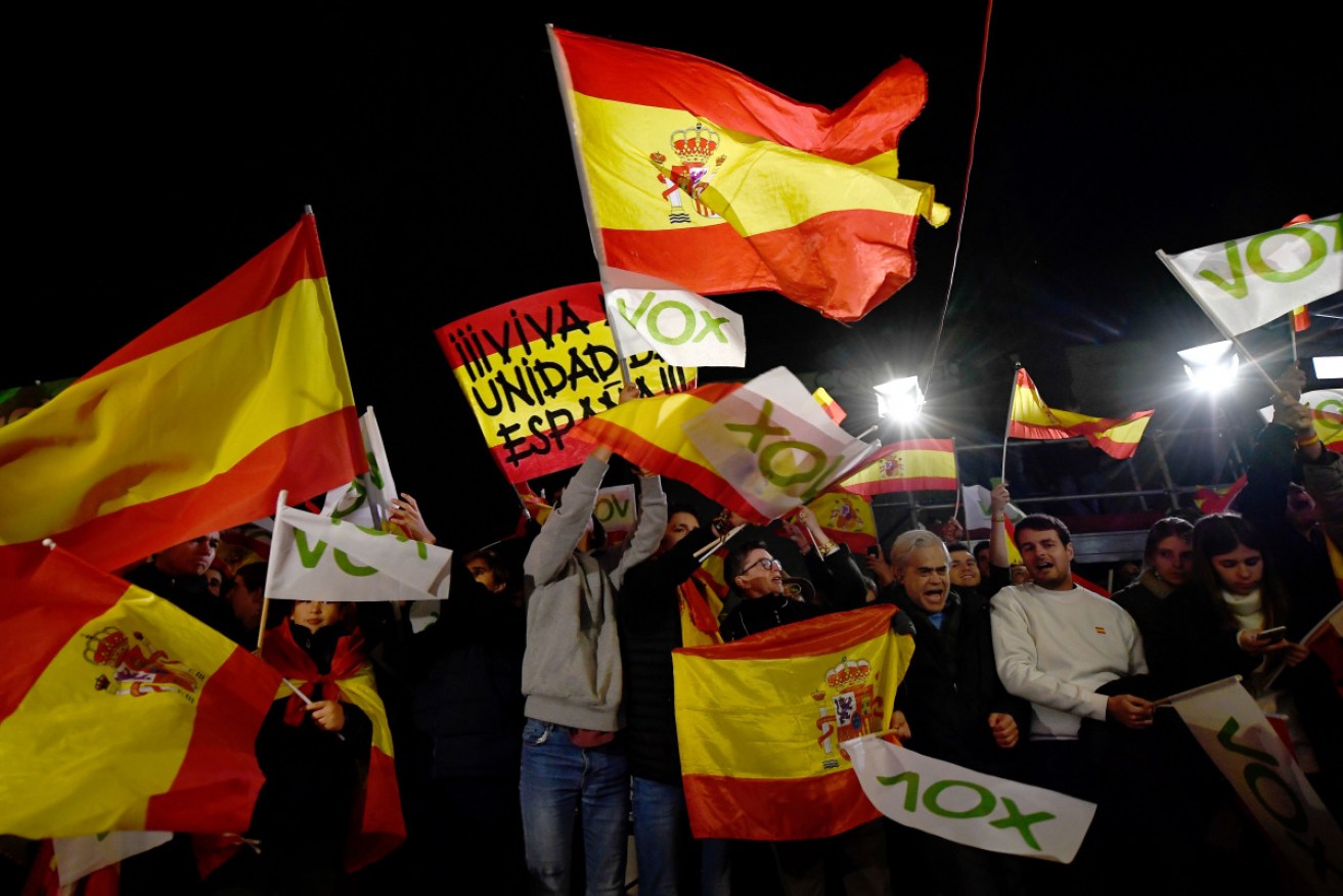 Spanish far-right party Vox supporters  celebrate outside the party's headquarters.