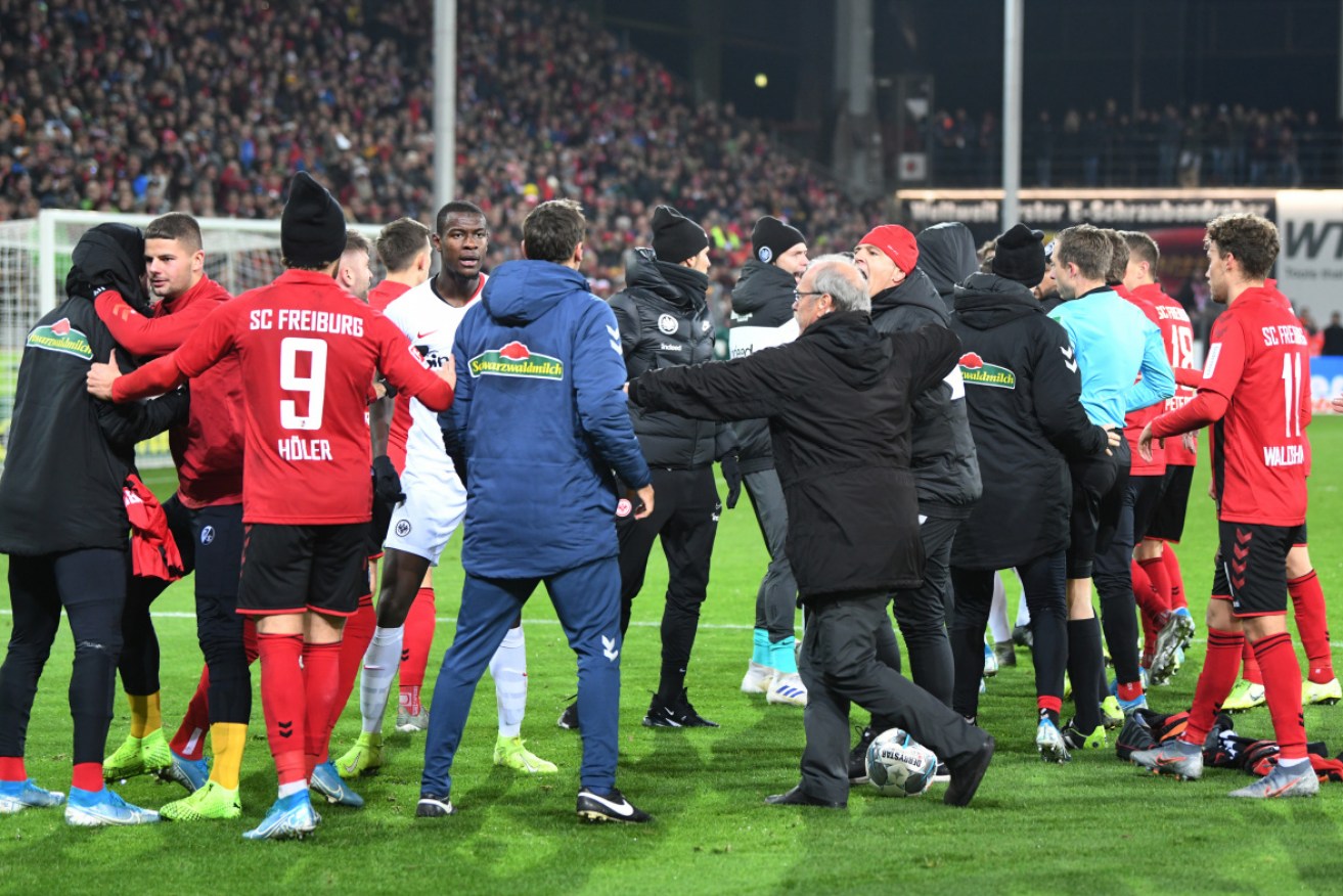 Eintracht Frankfurt captain David Abraham was sent off for knocking over Freiburg coach Christian Streich on the sideline on Sunday.