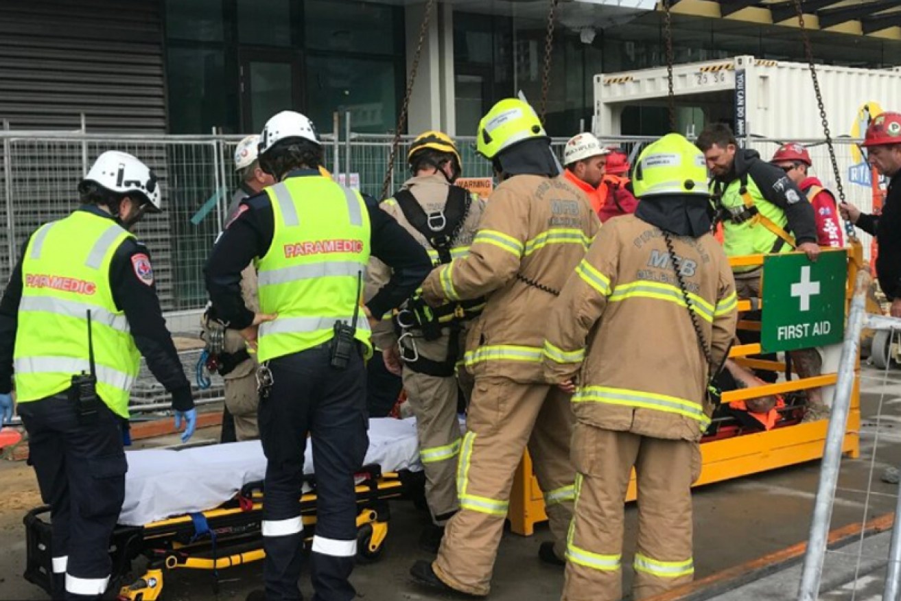 Specialist rescuers and paramedics attend to the injured man.