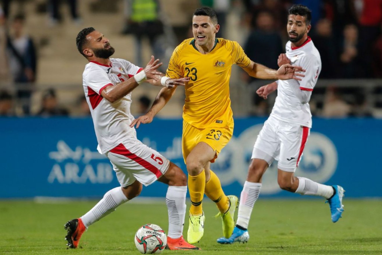 Australia's Tom Rogic tussles with Jordan's defender Yazan Abu Arab during the Group B FIFA World Cup 2022 and the 2023 AFC Asian Cup qualifying match. 