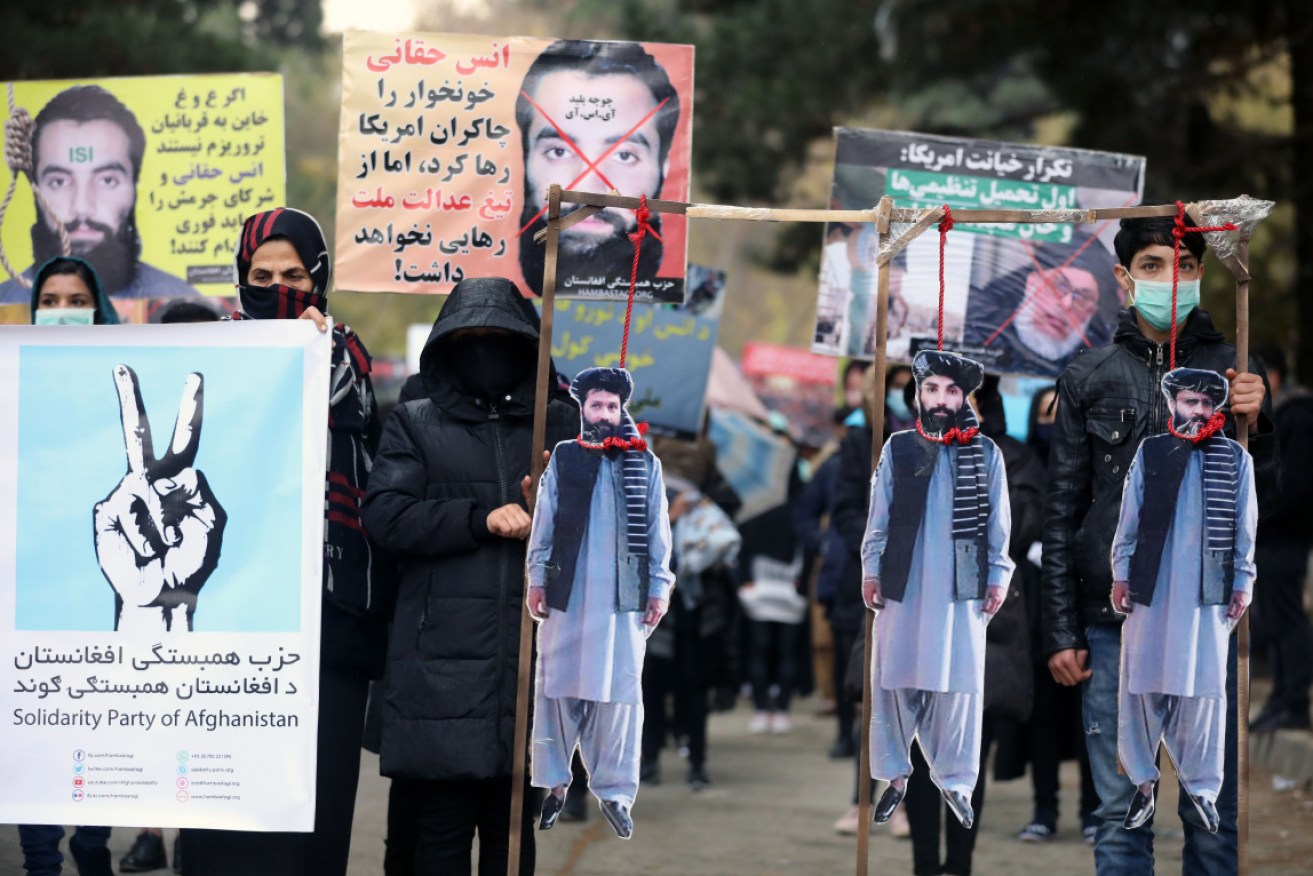 Afghan protesters carry the hanged effigies of freed prisoners at a protest in Kabul on November 15.