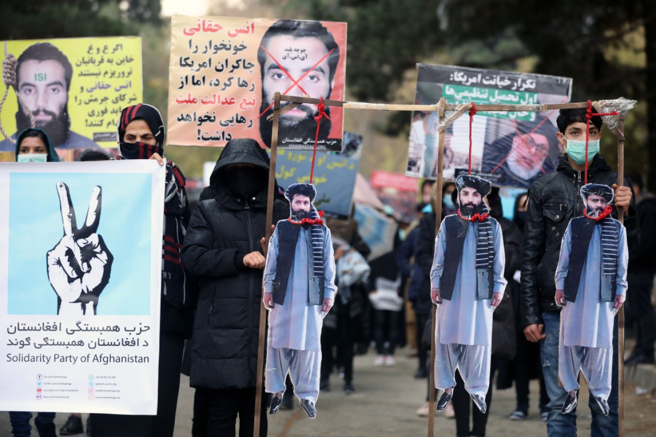 Afghan protesters carry the hanged effigies of freed prisoners at a protest in Kabul on November 15. 