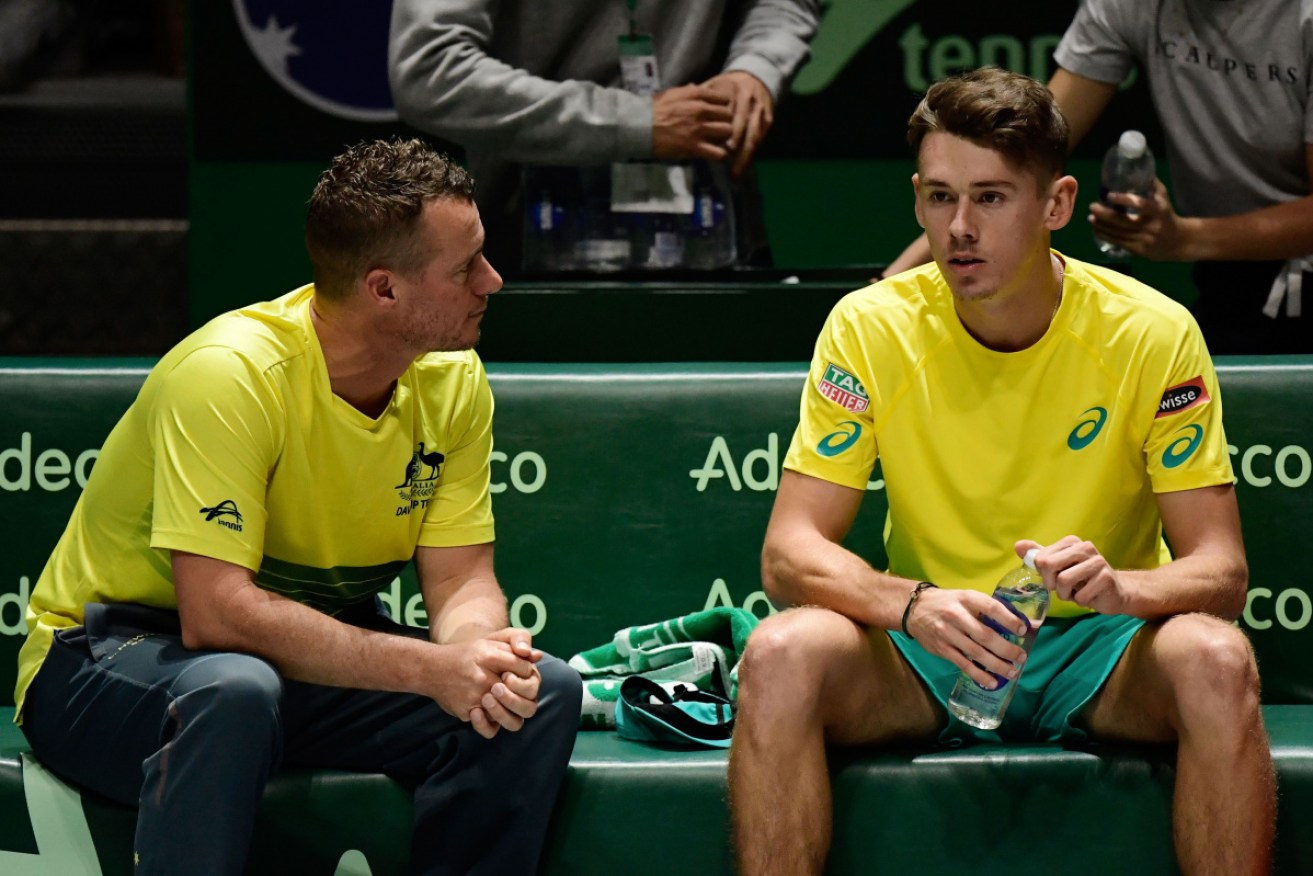 Alex de Minaur, right, pictured with team captain Lleyton Hewitt, has helped Australia over the line against Colombia.