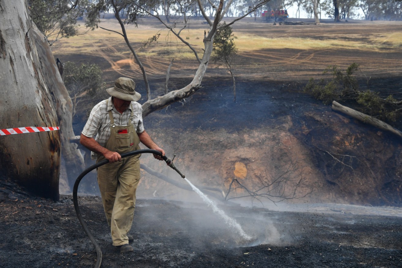 Tom Davies combats bushfires at Mount Glasgow, Victoria during a record-breaking hot day. 