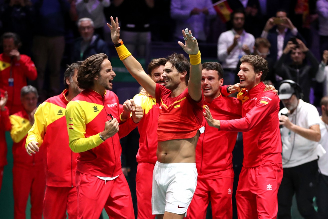 The Spanish team celebrates their win against Canada.