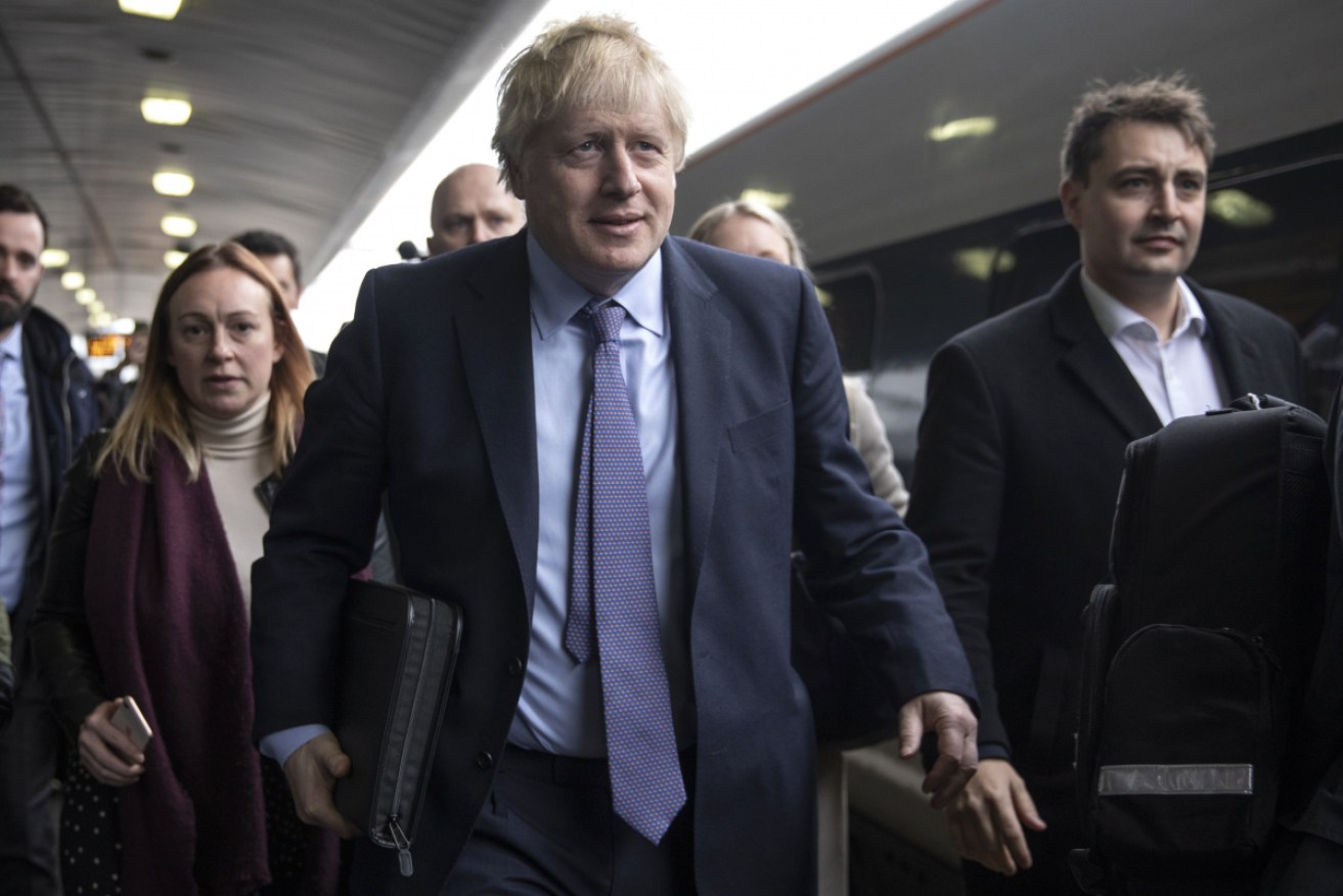 Boris Johnson departs a train as he travels to the launch of the Conservative Party election manifesto 
