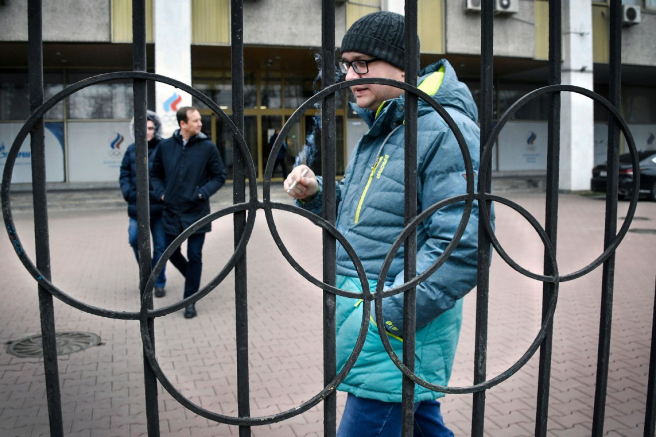 People walk outside Russian Olympic Committee headquarters in Moscow after news  the country may be barred from all sporting competition for four years.