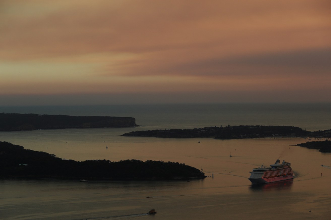 Sydney is choking amid heavy smoke, as properties near Batemans Bay have been lost due to an out-of-control bushfire.