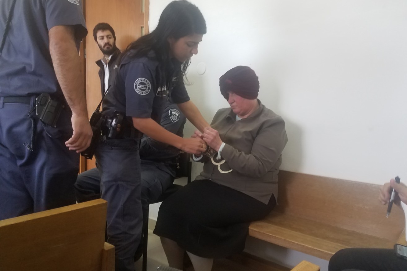Supplied photo from court in 2018 shows ex-Melbourne school principal Malka Leifer being handcuffed. 