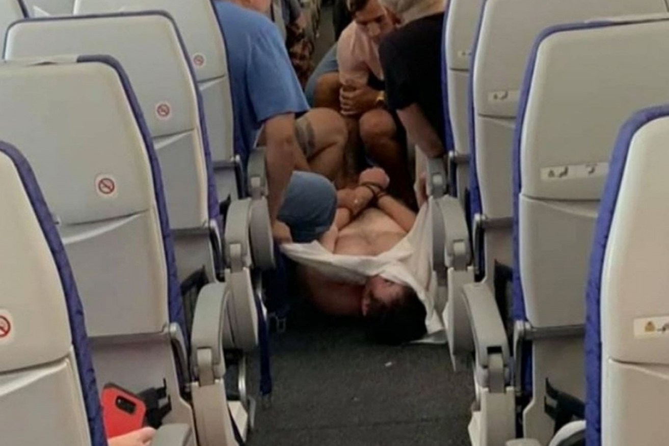 A Scoot flight was forced to turn back, and a man had to be physically restrained, after a brawl broke out mid-flight.