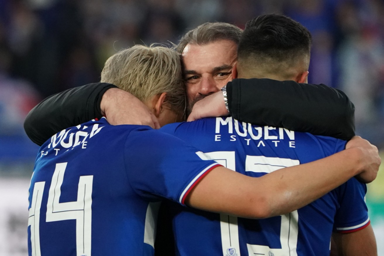 Ange Postecoglou celebrates with his Yokohama F.Marinos players after winning the J.League championship. 