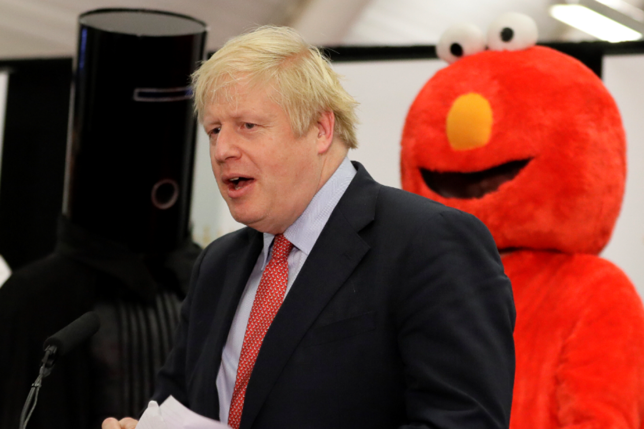 Boris Johnson hears he has increased his vote in an election also contested by Lord Buckethead (left) and Elmo of the Monster Raving Loony Party.