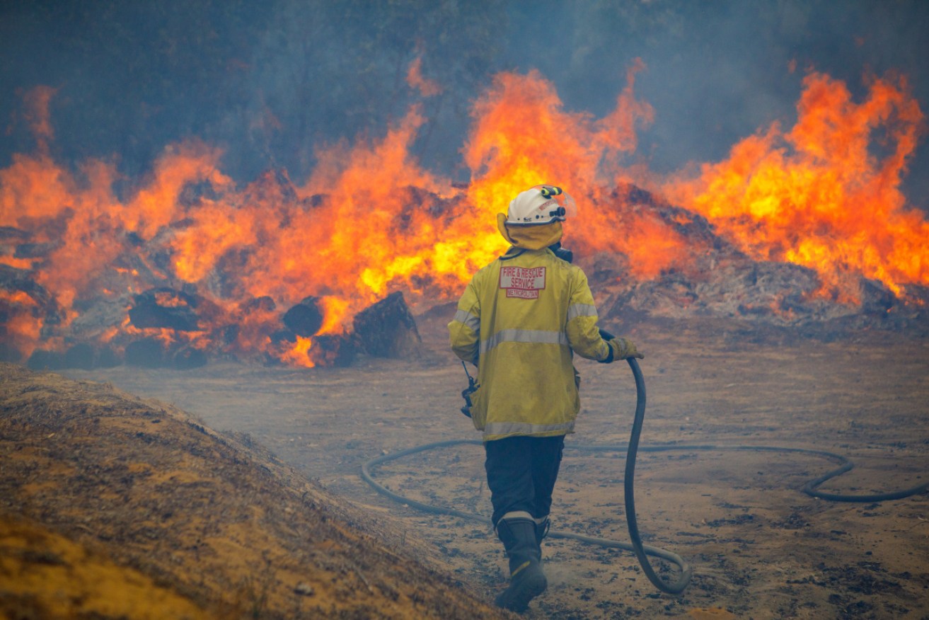 A fire at Yanchep, WA, has already destroyed a home and a service station and burned through 5000 hectares since Wednesday.