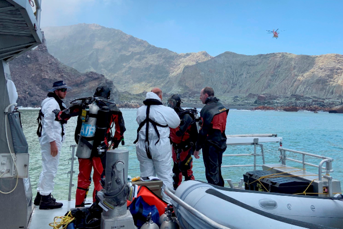 NZ police divers prepare to search the waters off White Island in a so-far fruitless quest for the last two victims' bodies.