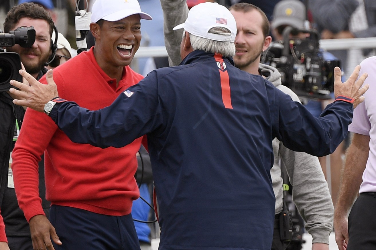 USA captain Tiger Woods, left, celebrates with vice captain Fred Couples.