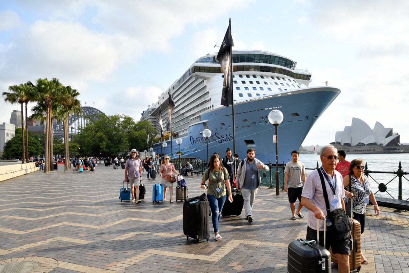 Passengers disembark from the Ovation of the Seas in Sydney.