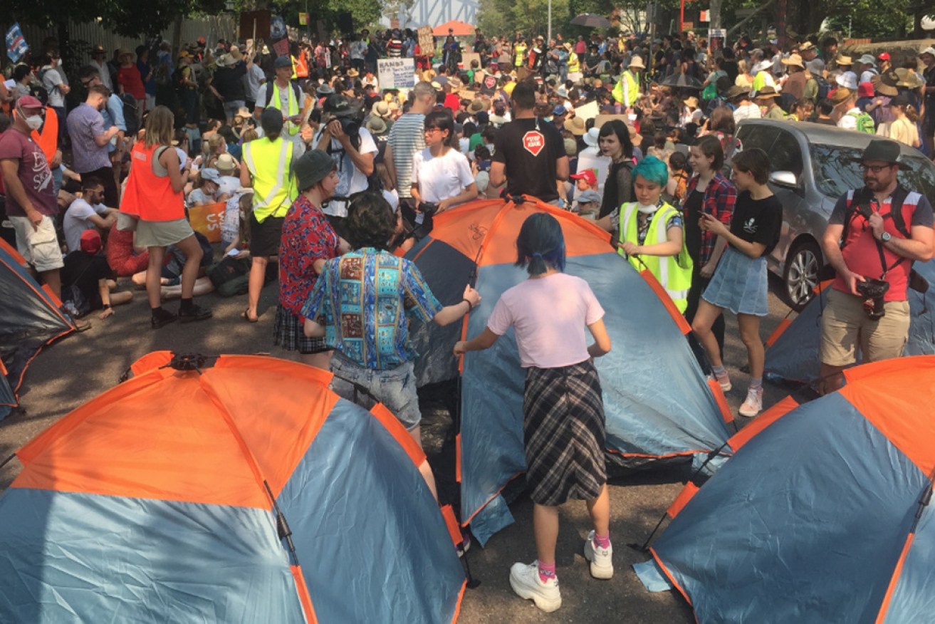 Climate change protesters set up tents for their camp outside Kirribilli on Thursday.