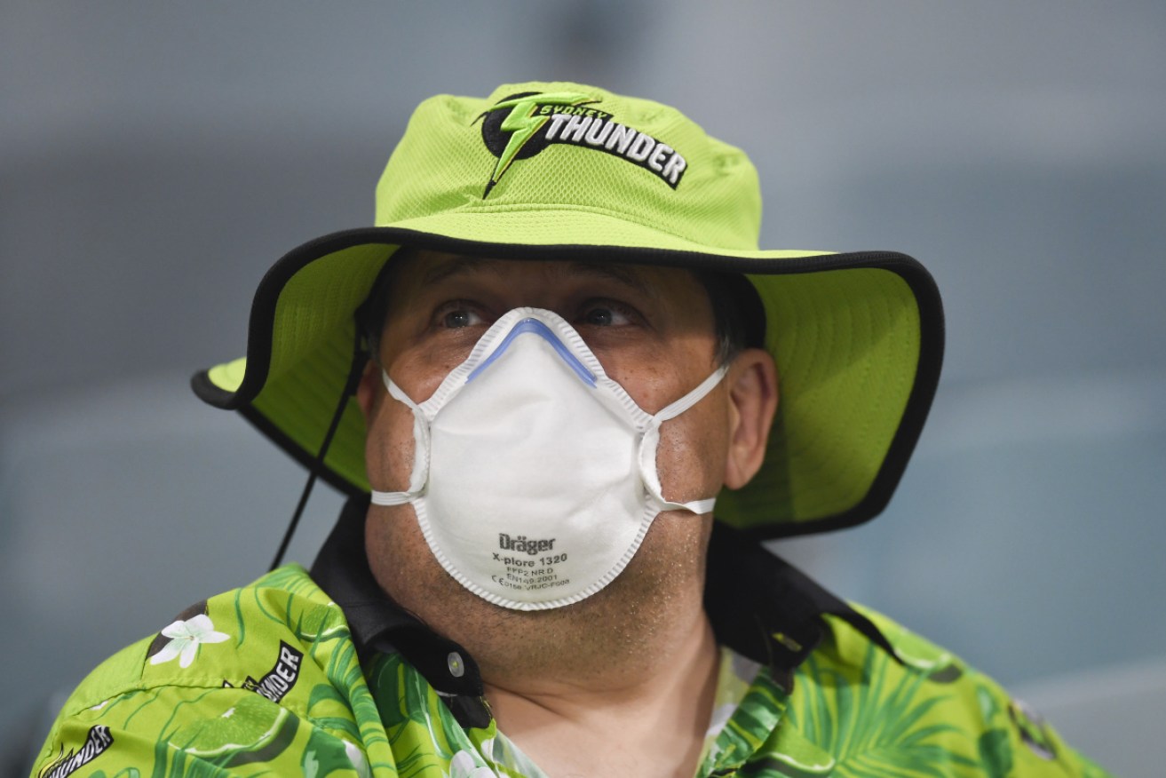 A Bg Bash fan wears a breathing mask before the game was called off. 