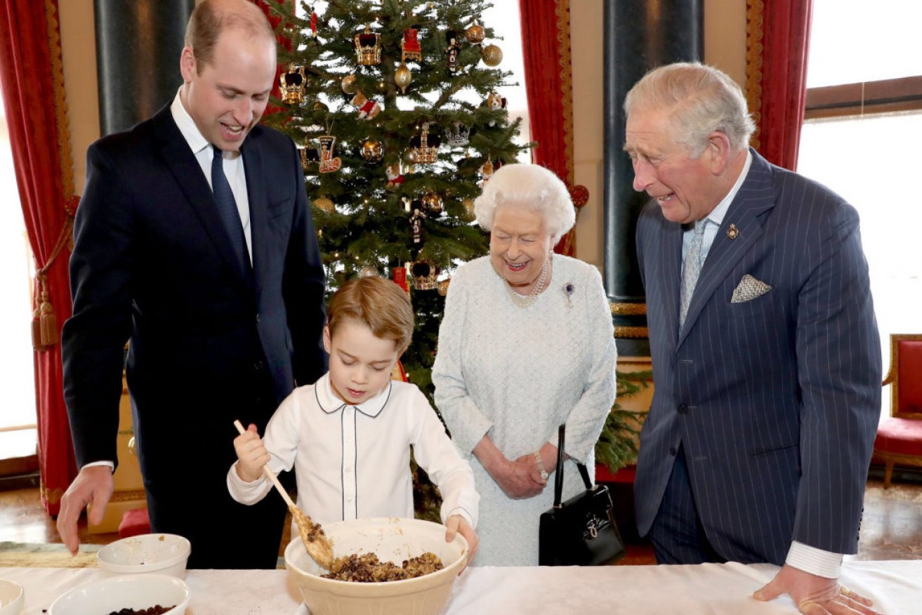 Prince George in 2019 mixes up the Christmas pudding, watched on by his proud dad, grandfather and great-grandmother Queen Elizabeth. 