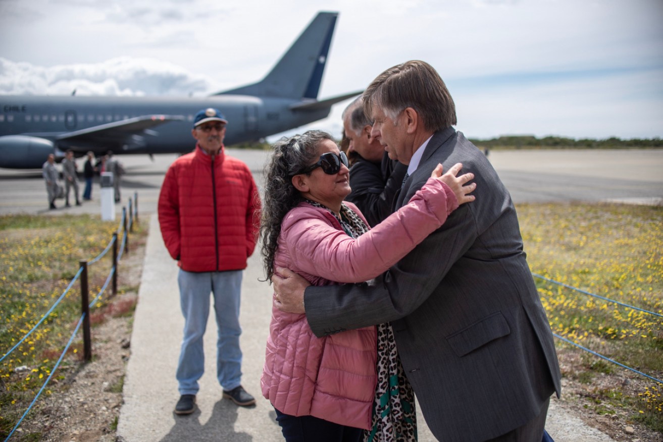 Relatives of people aboard the Chilean Air Force C-130 Hercules cargo plane arrive at Chabunco army base in Punta Arenas, Chile, on December 11.