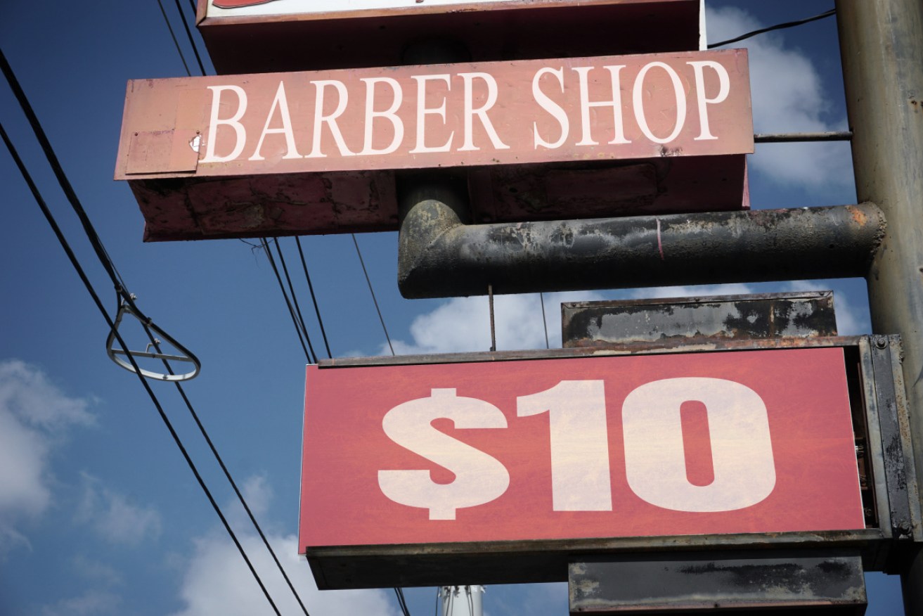 Police say the father and the barber got into an argument over a boy's haircut.