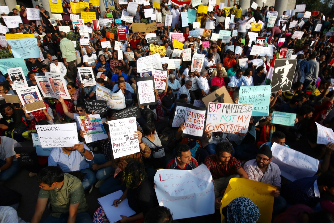 Indian protesters holds placard and shouts slogans during a protest against the Citizenship Amendment Bill. 