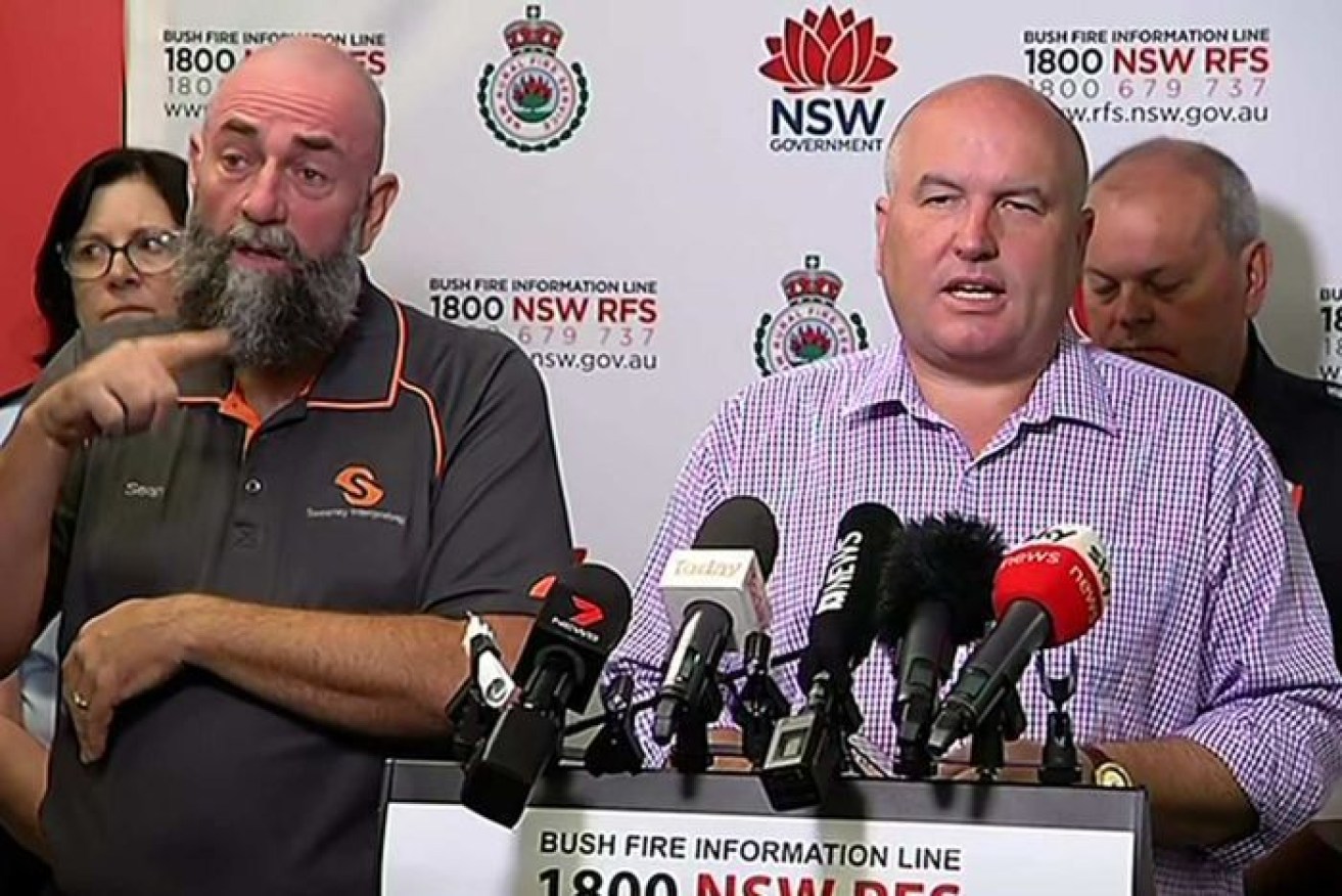 NSW Emergency Services Minister David Elliot will be travelling to Europe as bushfires and heatwaves ravage his state. 